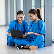 Two female doctors looking at a computer