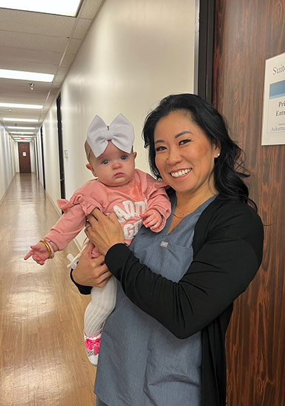 Certified Nurse Midwife Jana Sullivan, MSN is holding baby Emerson, who she helped deliver.