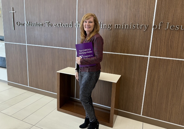 Kelly Miller standing in the CHRISTUS Health waiting room. 